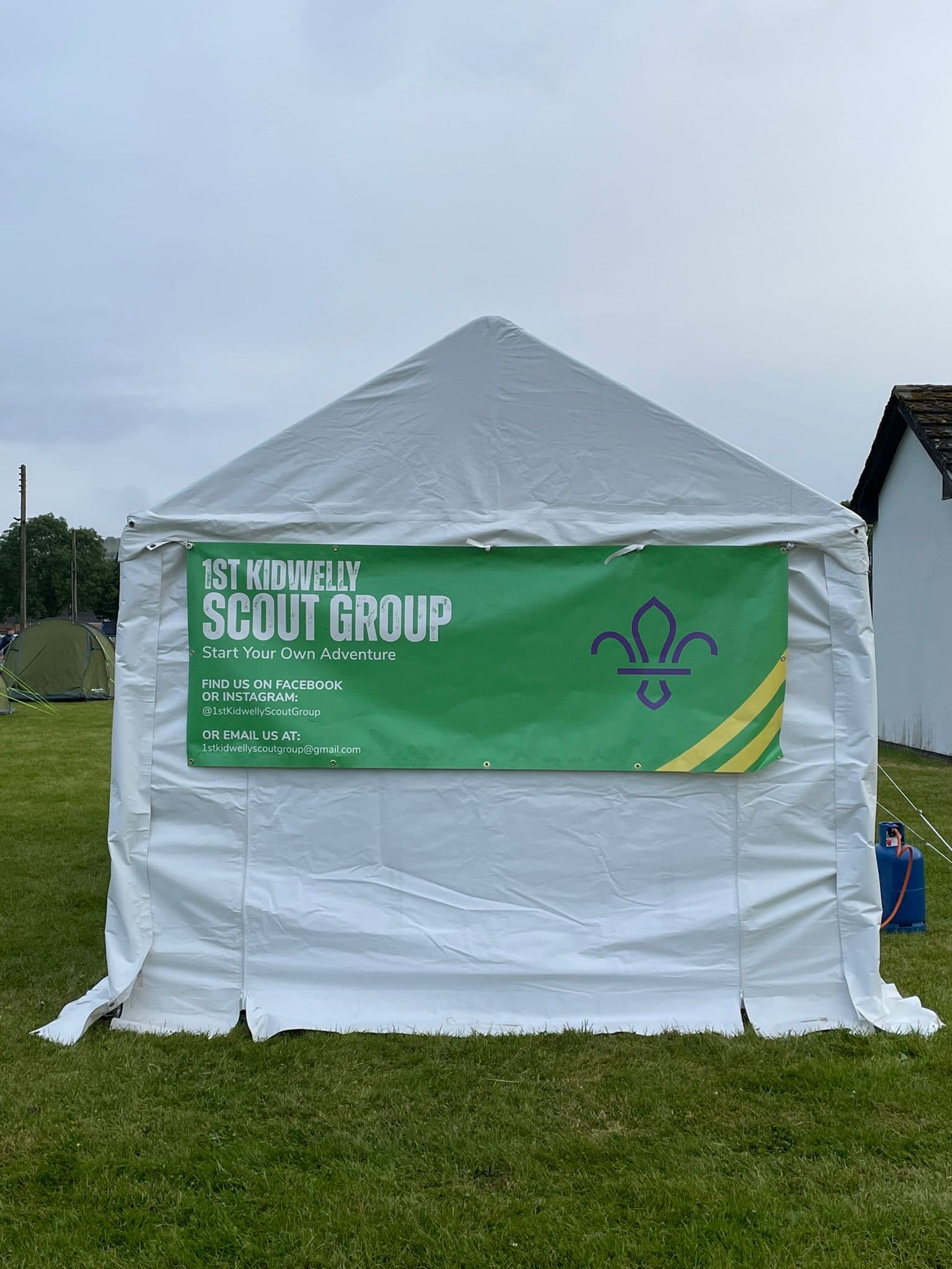 pitcure of the outside of a marquee with the kidwelly scouts banner showing